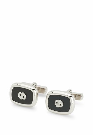 Silver and black cufflinks with an oval shape, featuring a glossy silver frame and a central black inlay, accented by a distinct emblem.