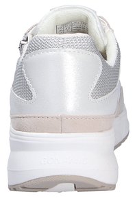 White athletic shoe with silver mesh accents, textured suede back, and a cushioned sole. Logo displayed on the heel. Zipper closure on side.