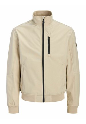 Veste beige zippée avec col montant, poche poitrine verticale zippée noire et deux poches latérales, présentée sur fond blanc.