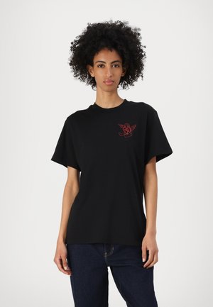 Black short-sleeve t-shirt made of cotton, featuring a small red graphic design on the left chest area. Simple, relaxed fit.