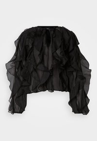 Blusa nera trasparente con dettagli arricciati, maniche lunghe e scollatura a chiave. Il tessuto è leggero e fluido, creando volume.