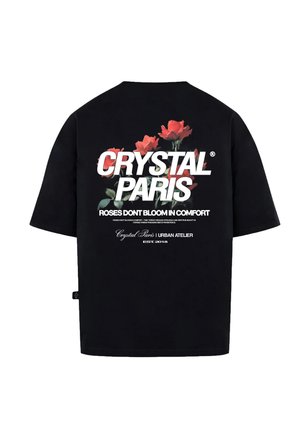 T-shirt nera oversize con grafica di rosa rossa e testo bianco: "CRYSTAL PARIS" e "LE ROSE NON FIORISCONO NEL COMFORT" sul retro.