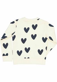 Krämmfärgad sweatshirt med marinblå hjärt-mönster; har långa ärmar och ribbad nederkant, tillverkad av mjukt bomullstyg.