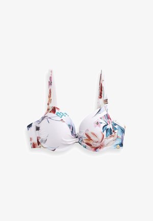 Lille lillekujundusega rinnahoidja valgel taustal, krohviga tassid, reguleeritavad sangad ja dekoratiivne sõlmikeskus. Kuldset aktsenti sisaldav riistvara.