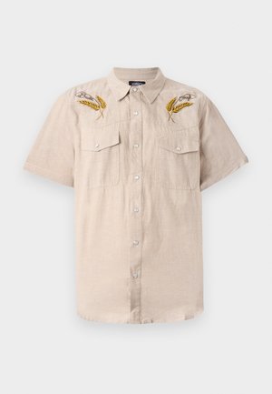 Beige kortermet skjorte laget av lin, med to brystlommer og broderte hvete-motiver i gult på skuldrene. Sølvknapper.