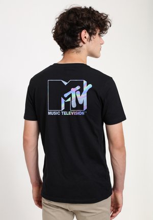 Black cotton t-shirt featuring a holographic MTV logo and "MUSIC TELEVISION" text on the back. Short sleeves and a classic crew neck design.