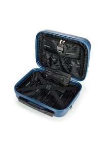 Valigia rigida blu con chiusura a zip. L'interno è foderato in tessuto nero, con tasche a zip e cinghie elastiche per fissare gli oggetti.