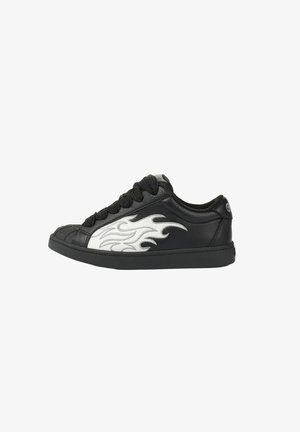 Black low-top sneaker with thick black laces and white flame design on the side, textured toe cap, and logo on the heel collar.