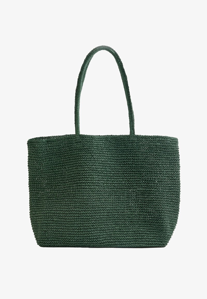 Sac cabas tissé vert foncé avec deux poignées d'épaule et une base rectangulaire, conçu pour transporter des effets personnels.