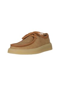 Tan suede casual shoe with thick beige sole and brown laces, displayed against a white background.