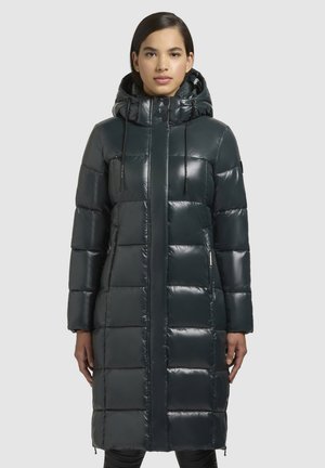 Donkerblauwe pufferjas met een glanzende afwerking, voorzien van een capuchon, een rits aan de voorkant en een elastische trekkoord, gewatteerd design en zijzakken.