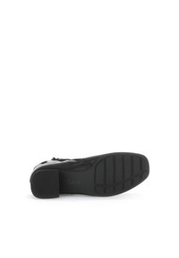 Zwarte leren schoen met een ronde neus en een lage hak. Getextureerde zool met groeven voor grip. Merklogo ingebosseld op het hielgebied.