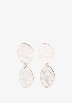 Silver dangle earrings featuring two distinct oval shapes with a hammered texture, connected by a small loop. Minimalist design.