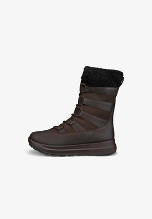 Brun vattentålig sko med en mjuk svart krage, syntetiskt material, gummisula och flera elastiska remmar för justering. Texturerad ovansida.