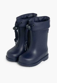 Bottes de pluie en caoutchouc bleu marine avec une surface texturée, cordon de serrage ajustable à la cheville et semelle plate rainurée pour une meilleure adhérence.