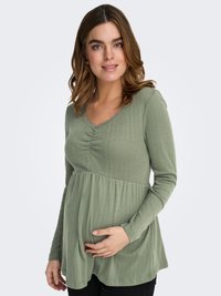 Ribbed, long-sleeve maternity top in olive green with a scalloped neckline, waistline pleats, and a relaxed fit, designed for comfort.