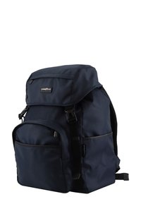 Navy blue nylon backpack with a top flap, adjustable straps, side pocket, and subtle logo. Features a durable, smooth texture.