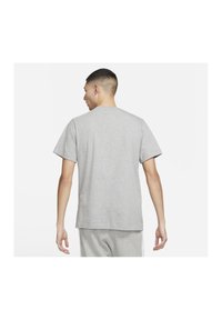 Grå kortærmet t-shirt med rund hals, glat stoftekstur og en afslappet pasform, set bagfra.