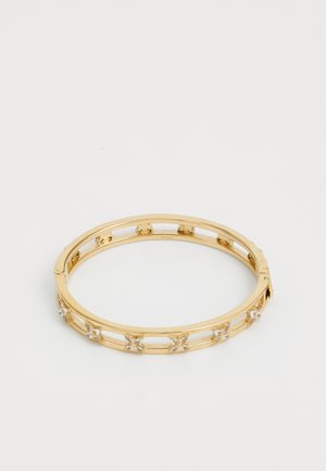 Gold metal bangle bracelet featuring clear gemstones in star-like shapes, open design with a smooth finish and secure clasp.