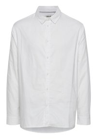 Camisa blanca de manga larga de algodón con cuello abotonado, tapeta frontal y dobladillo curvado. Presenta botones en tono y un corte relajado.