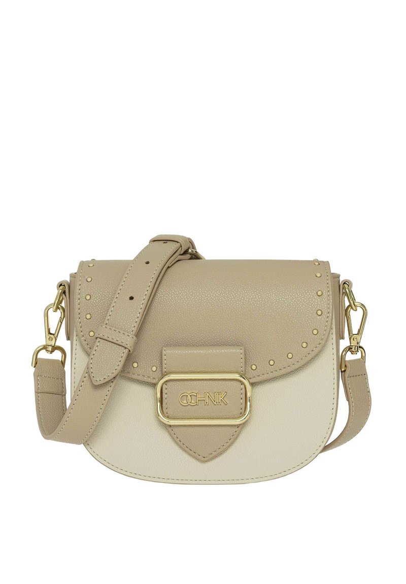 Beżowa skórzana torba na ramię z złotymi akcentami, nitowanymi detalami, z klapką i regulowanym paskiem. Z przodu znajduje się plakietka z logo.
