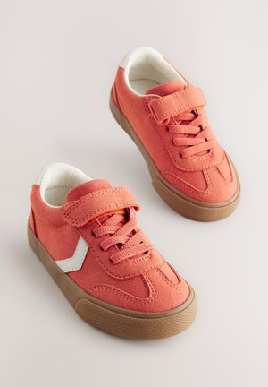 Oranžni semiš supergi s teksturirano površino, belimi poudarki, ježkom in vezalkami. Gumijasti podplati s protizdrsnim vzorcem.