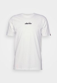 T-shirt blanc à manches courtes avec petit logo noir "ellesse" et graphisme demi-soleil centré sur la poitrine.