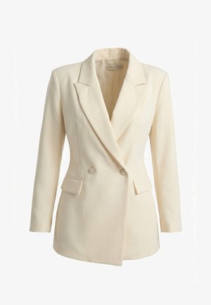 Blazer croisé couleur crème avec revers crantés, deux poches à rabat à l'avant et manches longues.