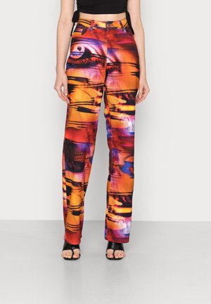Calças largas coloridas com padrões abstratos em laranja, roxo e preto; feitas de denim; apresentam cinco bolsos e um fecho com botão.