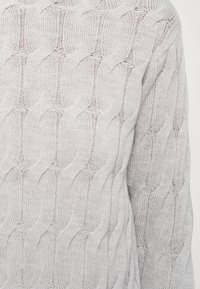 Light gray knitted sweater with a textured pattern resembling interwoven loops, featuring a loose fit and ribbed hem.