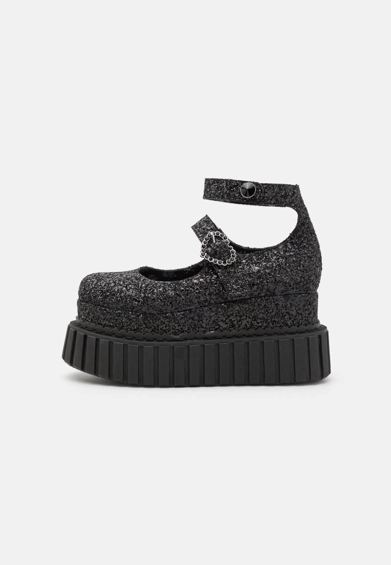 Black glitter platform shoes with a rounded toe and ankle strap. Features a heart-shaped buckle and ribbed sole for added grip.