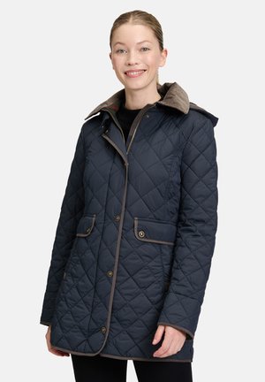 Marineblau gesteppte Jacke mit braunem Cordkragen, Drop-Waist, Fronttaschen und Druckknopfverschluss. Strukturierte Oberfläche mit kontrastierenden Besätzen.