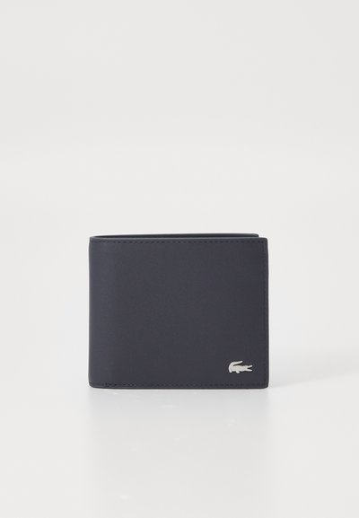 Portefeuille en cuir bleu marine avec une texture lisse, au design pliable en deux, et un accent logo crocodile argenté à l'avant.