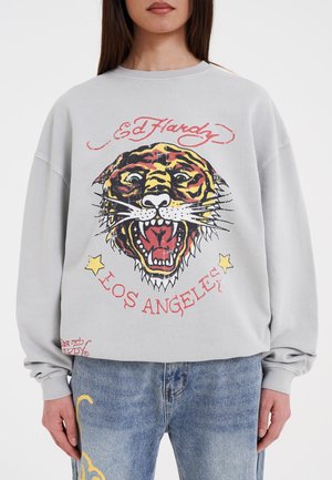 Gray sweatshirt with oversized fit featuring a colorful tiger graphic and "Ed Hardy Los Angeles" text in red. Long sleeves with ribbed cuffs.