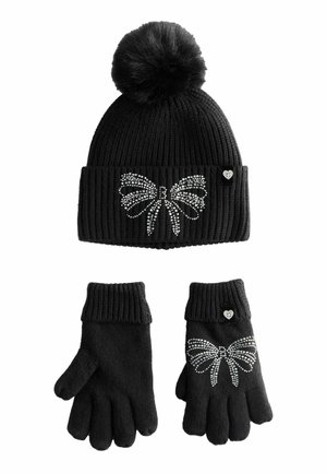Black knit hat with a pom-pom and rhinestone butterfly design; paired with matching gloves featuring a similar butterfly accent.