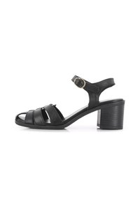 Las sandalias de tacón de cuero negro presentan un diseño con tiras, con una correa en el tobillo y un hebilla. El tacón es de forma bloque y tiene una superficie texturizada.