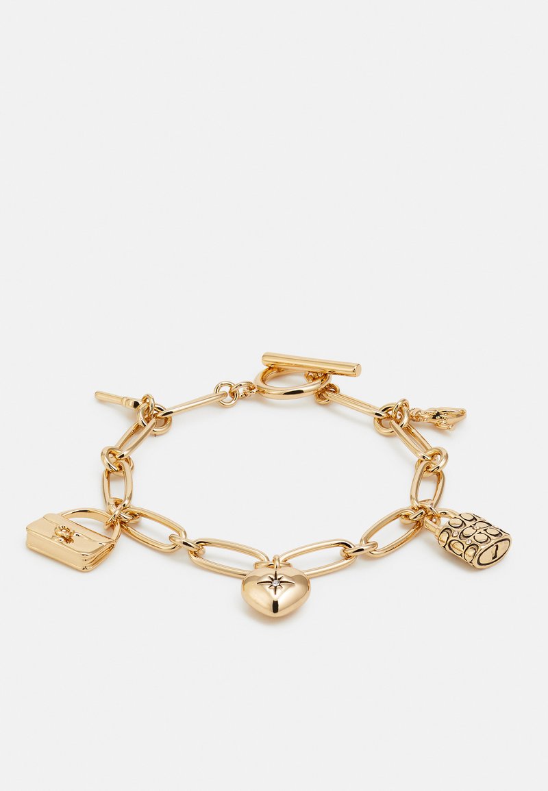 Gold chain bracelet featuring large links and three charm pendants: a heart, a handbag, and a textured round charm with details.