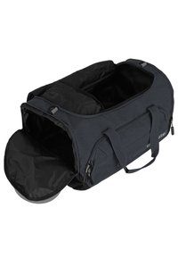 Sac de voyage en tissu gris avec intérieur noir, poignées doubles et poches zippées. S'ouvre largement pour un accès facile ; matériaux durables.