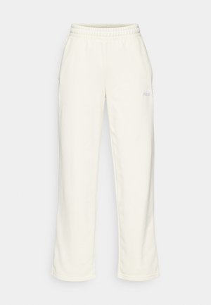 Krémové tepláky vyrobené z mäkkej látky, s elastickým pásom a voľným strihom. Nenápadný logotyp na prednej strane.