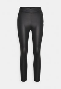 Leggings deportivos negros con una cinturilla alta y cruzada. Están hechos de un material suave y elástico, con un diseño ajustado y longitud hasta el tobillo.