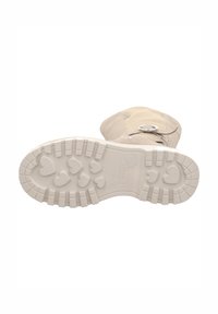 Hellbeige Stiefel mit einem strukturierten Wildleder-Obermaterial, ausgestattet mit einer silbernen Schnalle und einer weißen Gummisohle, die mit Herzformen geprägt ist.