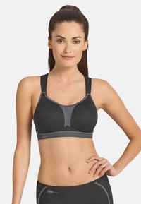 Schwarzer Sport-BH mit grauen Akzenten, ausgestattet mit breiten, verstellbaren Trägern, einem Netzpanel und einer glatten Textur. Geeignet für aktive Sportbekleidung.