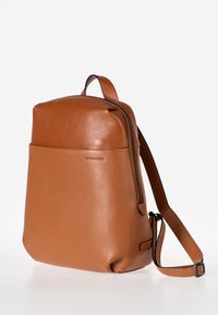 Zaino in pelle marrone con una texture liscia, design slim, chiusura con zip, tracolla regolabile e tasca frontale.