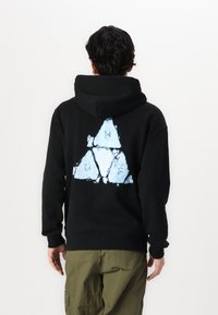 Black hooded sweatshirt with a light blue triangular graphic on the back. Cotton material, ribbed cuffs, and waist.