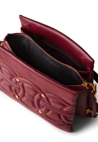 Burgundy leather bag with a textured design, gold hardware, and a zip closure. Interior features a contrasting black lining.