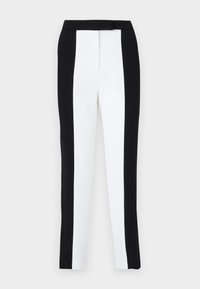 Musta-valkoiset kapenevat housut, joissa on slim fit-malli ja erottuvat paneelit. Kangas on sileä, ja vyötärö on litteä ja hyvin istuva.