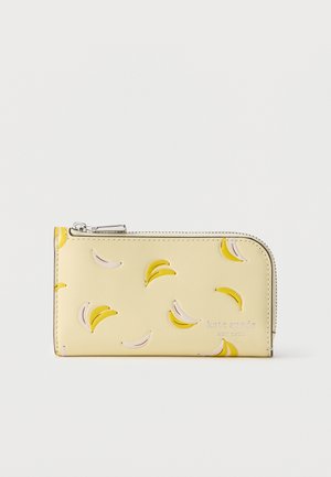 Hele kollane tõmblukuga rahakott, kus on reljeefsed banaanikujundused ja esiküljel "kate spade new york" logo.