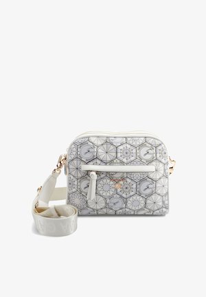 Witte crossbodytas met geometrische zwarte lijnpatronen, hexagonale logo's, voorvak met ritssluiting en brede verstelbare schouderband met goudkleurige hardware.