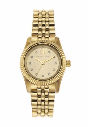 Gold Michael Kors wristwatch with a metal link band, round face, Roman numeral XII, and crystal hour markers showing 10:10:35.