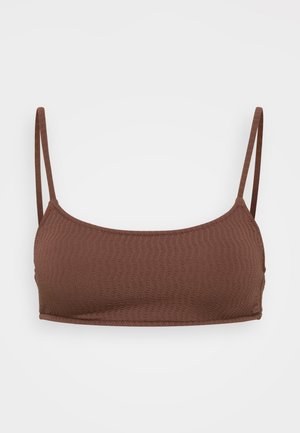 Brown patterned crop top with thin adjustable straps and a smooth, textured fabric. Features a rounded neckline and elastic trim.